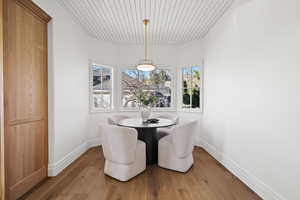 Dining room with wood ceiling and hardwood / wood-style floors