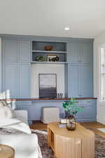 Living area with dark wood-style flooring and recessed lighting