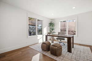 Office featuring hardwood / wood-style flooring and recessed lighting