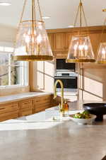 Kitchen featuring wood finish cabinets, stainless steel appliances, and light countertops