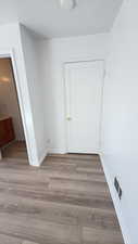 Hall with light wood-type flooring and baseboards