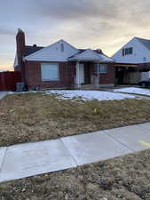 Ranch-style house with brick siding and a chimney