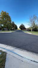 View of asphalt road with sidewalks and curbs