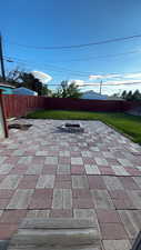 Fenced backyard with a patio
