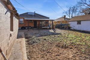 Rear view of property with brick siding and a deck