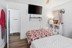 Bedroom featuring dark wood-style floors and ceiling fan