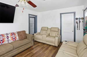 Living area featuring wood finished floors and a ceiling fan