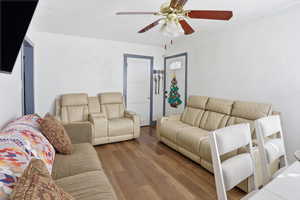 Living room featuring wood finished floors and a ceiling fan