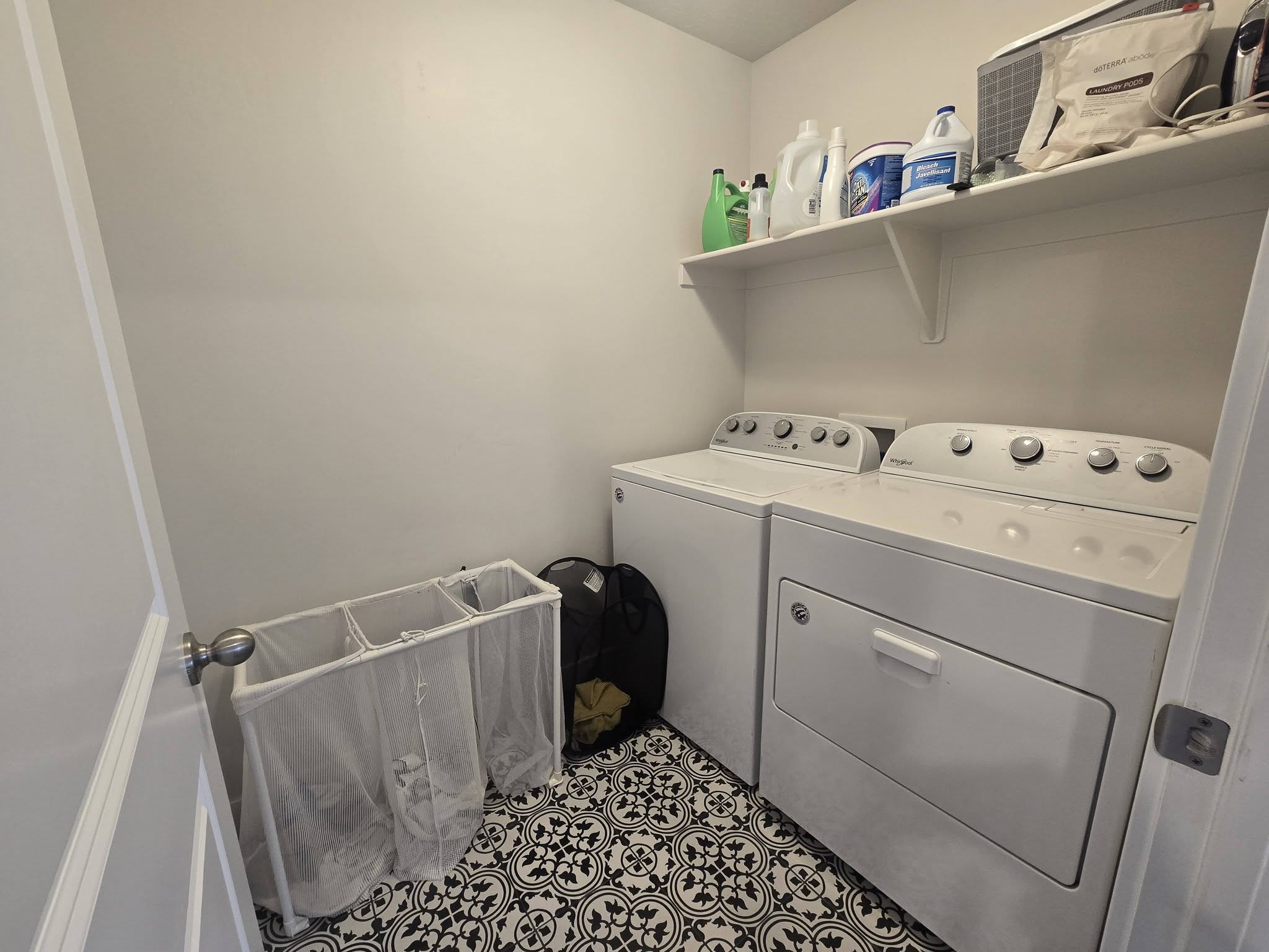 Laundry area with separate washer and dryer and tile patterned flooring