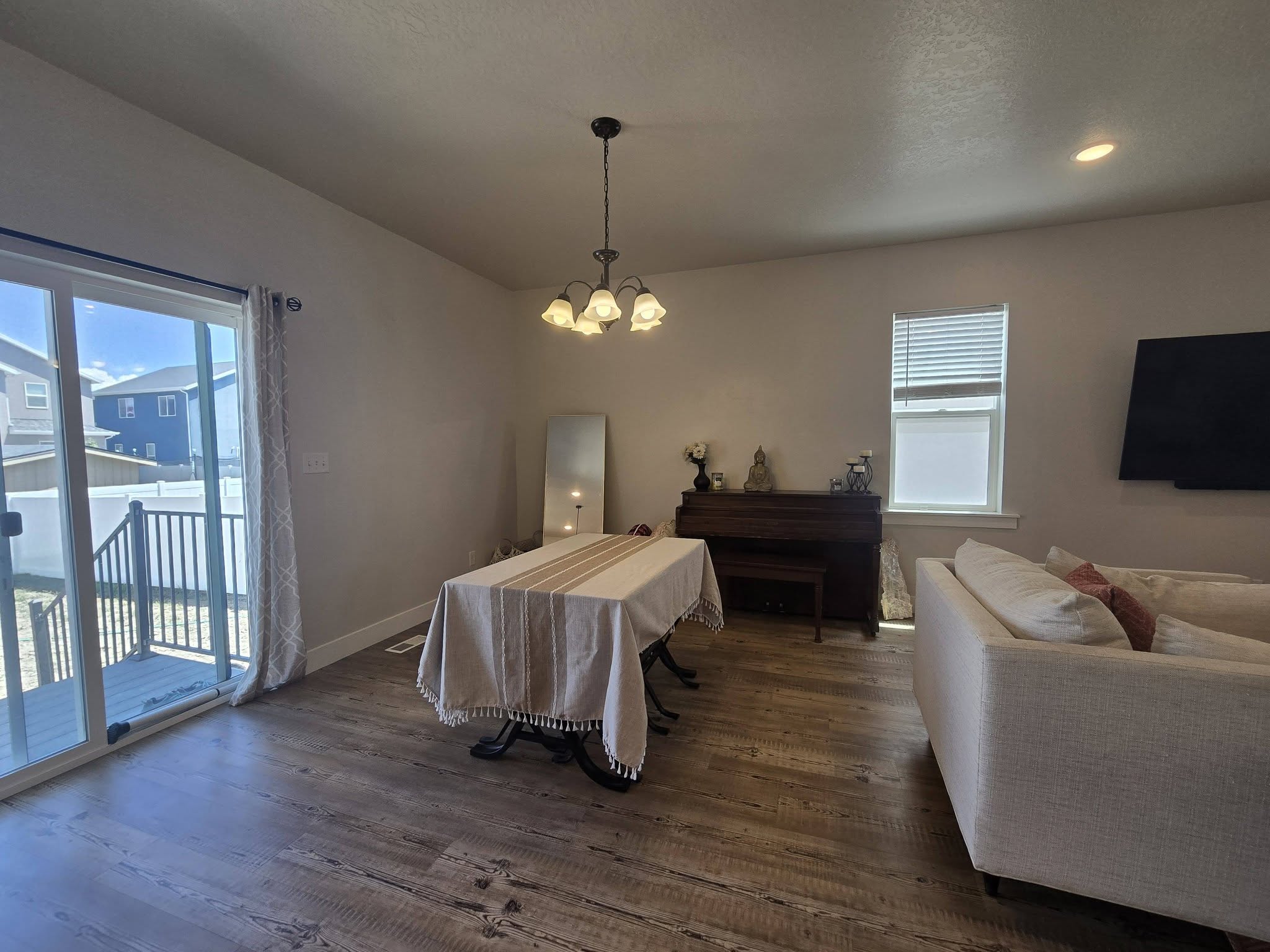Dining area with dark wood-type flooring and hanging lights