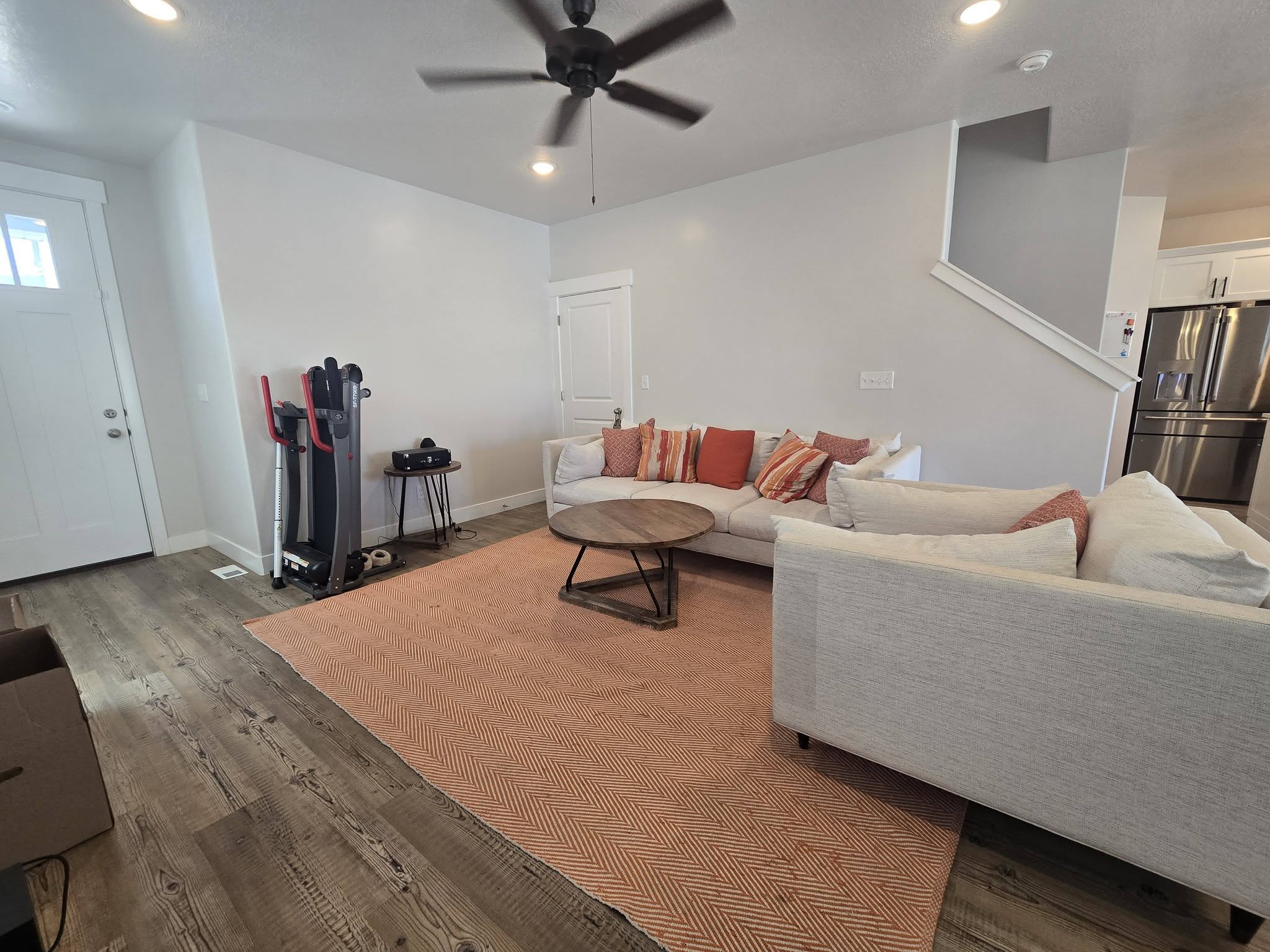 Living area with a ceiling fan, recessed lighting, and light wood-type flooring
