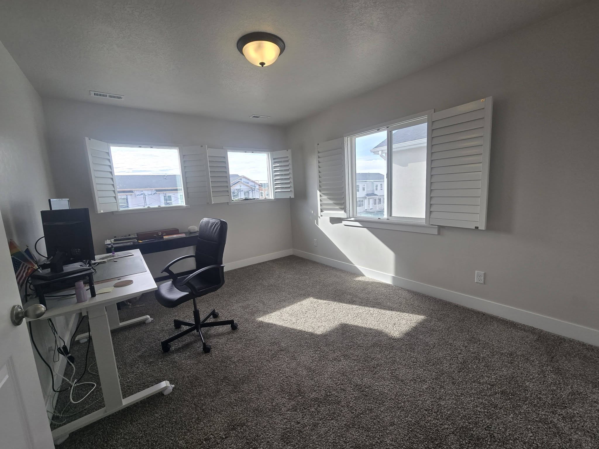 Carpeted office with a textured ceiling