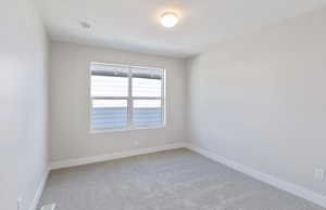 Bedroom 2 featuring light carpet and baseboards