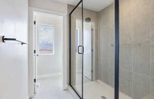 Owner's bathroom with a stall shower and baseboards