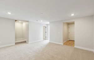 Finished basement featuring recessed lighting and light carpet