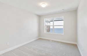 Bedroom 3 featuring baseboards and light colored carpet