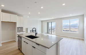 Kitchen with white cabinetry, light wood-type flooring, a mountain view, and recessed lighting