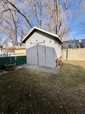 View of shed with a fenced backyard