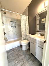 Bathroom with vanity and shower / bath combo with shower curtain