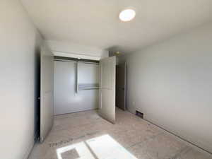 Unfurnished bedroom with a closet