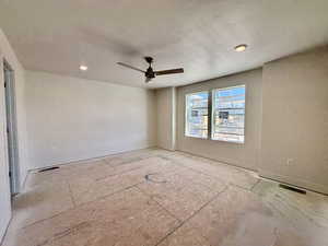 Empty room with recessed lighting, ceiling fan, and a textured ceiling