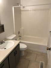 Bathroom with vanity,  shower combination, and light tile patterned floors