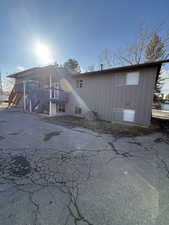 View of front of house with stairway and a deck
