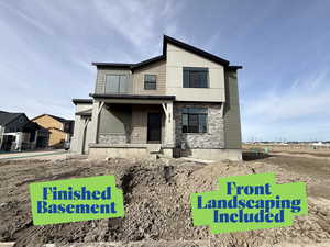View of front facade featuring a porch and stone siding