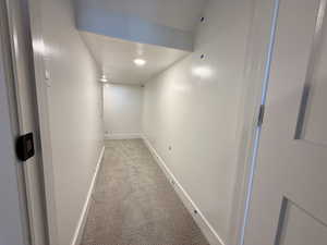 Hall with carpet floors and recessed lighting