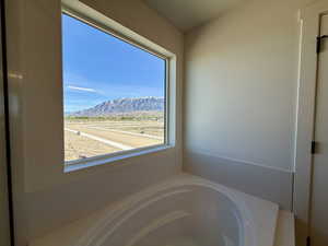 Full bathroom with a mountain view and a garden tub