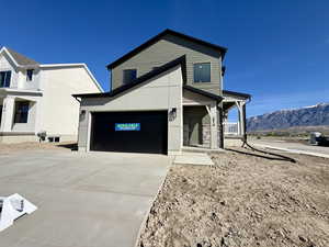 Modern home featuring a porch, driveway, and a mountain view