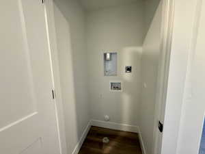 Laundry area with dark wood-type flooring and washer hookup