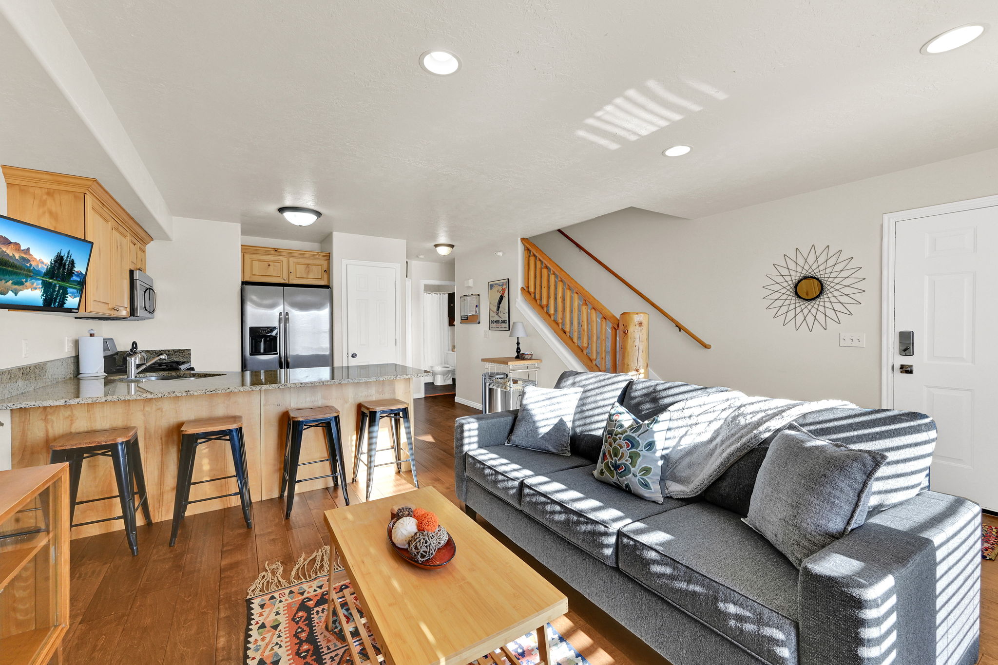 Living area with dark wood-type flooring and recessed lighting
