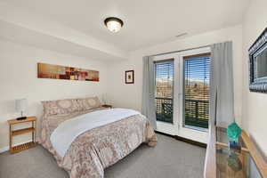 Bedroom featuring access to exterior and carpet flooring