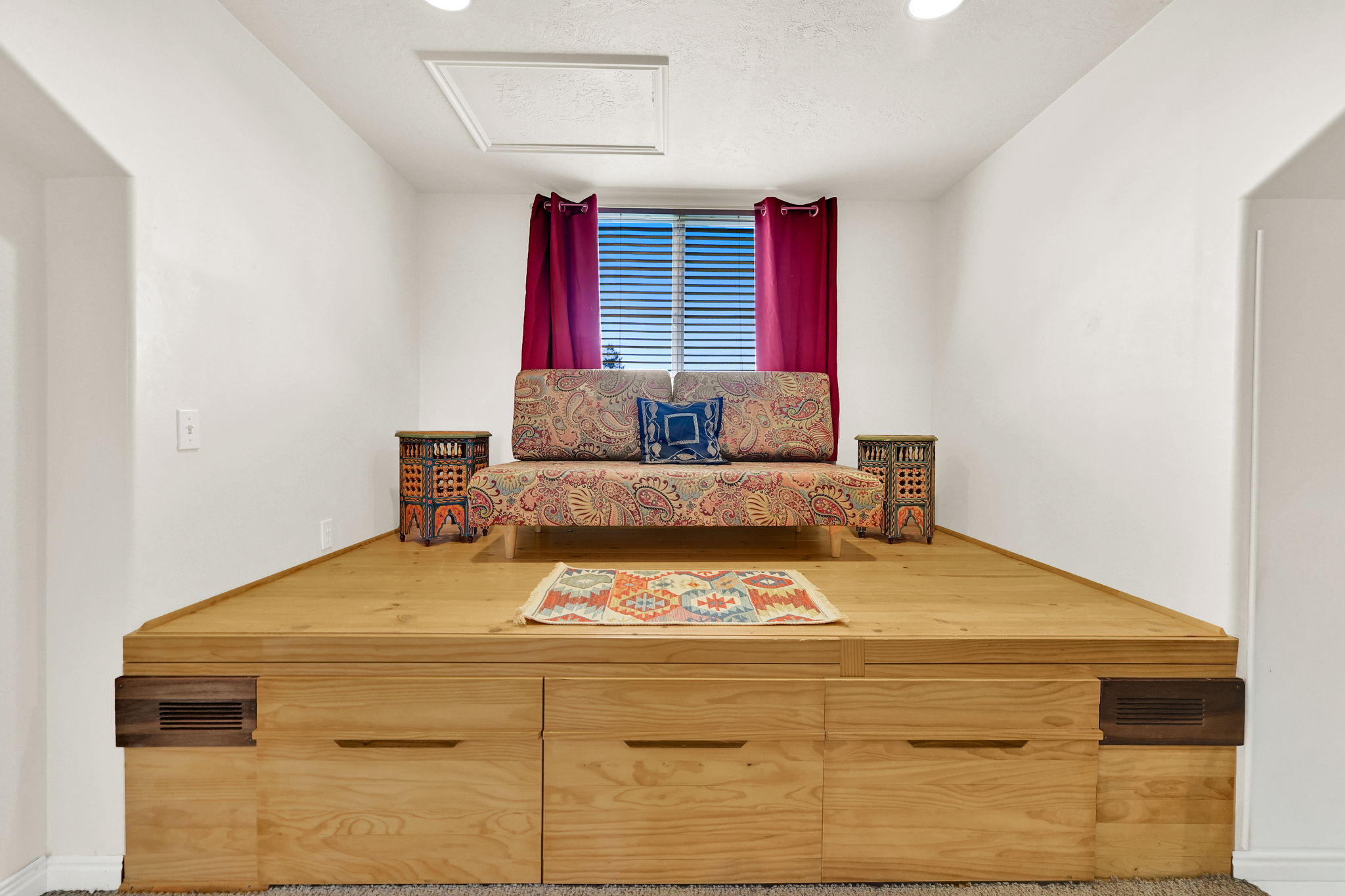 Elevated platform featuring light wood-finish construction with integrated storage drawers