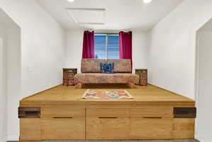 Elevated platform featuring light wood-finish construction with integrated storage drawers