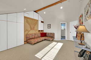 Living area featuring light colored carpet and recessed lighting