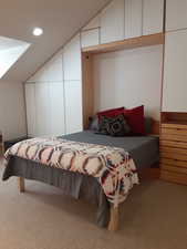 Bedroom featuring vaulted ceiling, light colored carpet, and recessed lighting