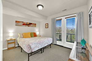 Bedroom featuring light gray wall paint and neutral carpeting