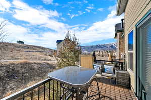 Balcony featuring a mountain view and outdoor dining area