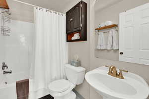 Full bathroom with shower / bath combo and toilet