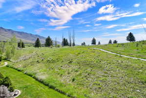 Expansive green landscape featuring rolling hills and distant mountains
