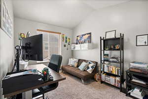 Carpeted office with vaulted ceiling