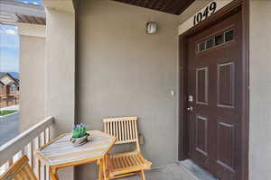 Doorway to property featuring stucco siding