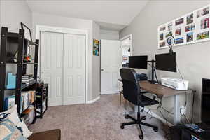Home office featuring light colored carpet and baseboards