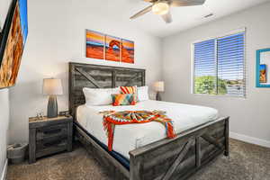 Bedroom featuring dark colored carpet and a ceiling fan