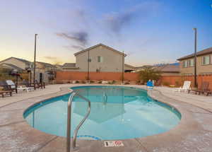 Community pool featuring a patio and a residential view
