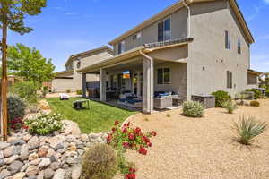 Back of property featuring outdoor furniture, a patio area, and stucco siding