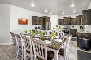 Dining area featuring recessed lighting and light tile patterned floors