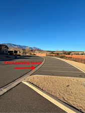 View of asphalt street featuring curbs and a mountain view